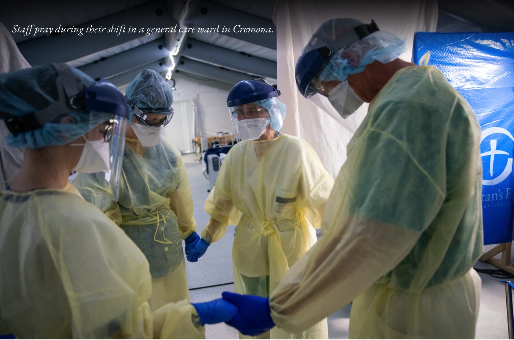 Profissionais de saúde a orar no hospital de campanha em Cremona, Itália - Bolsa do Samaritano